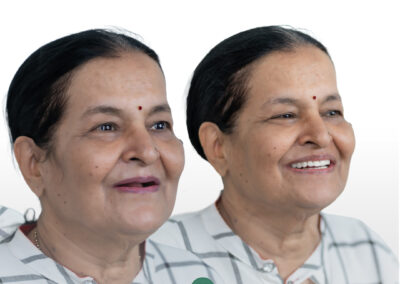 Two smiling women with dark hair in light plaid shirts pose together for a dental clinic photo, logo 'Dr. Namratha Implantologist' visible at the bottom.